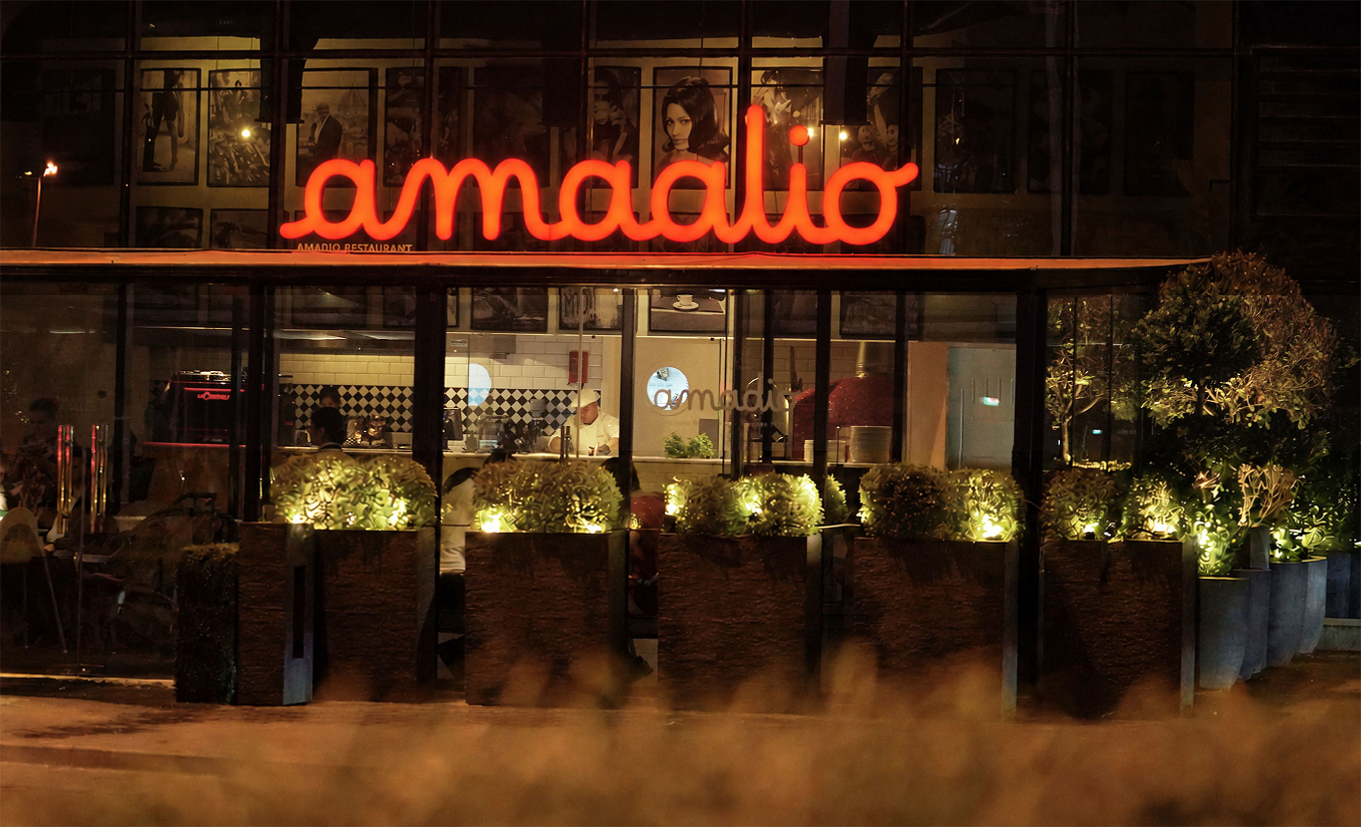 Amadio restaurant storefront at night